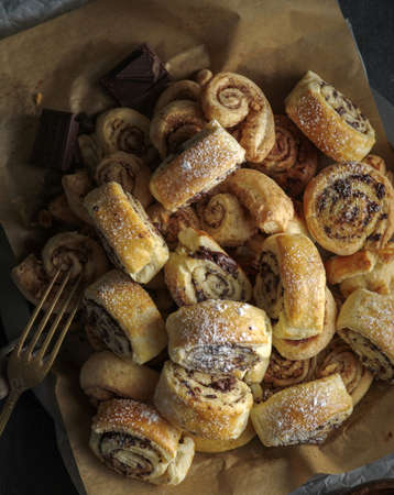 Buns with cinnamon and chocolate on a dark wooden table. Country style.の写真素材