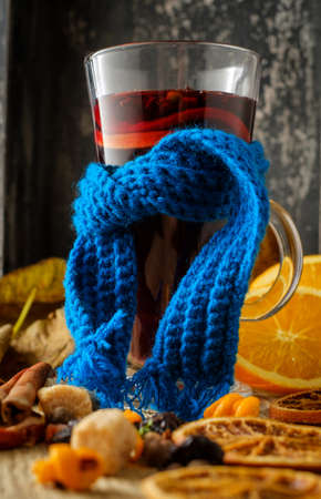 Christmas hot mulled wine with orange, cinnamon, cardamom and anise on wooden background.の写真素材