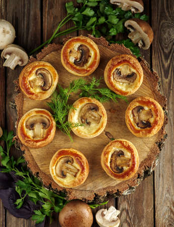 Delicious puff pastry with mushrooms on th wooden table, rustic style.の写真素材