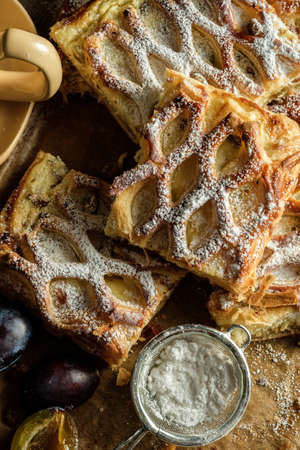 Close up dark rustic style Apple strudel. Sliced homemade apple strudel, top view.の写真素材
