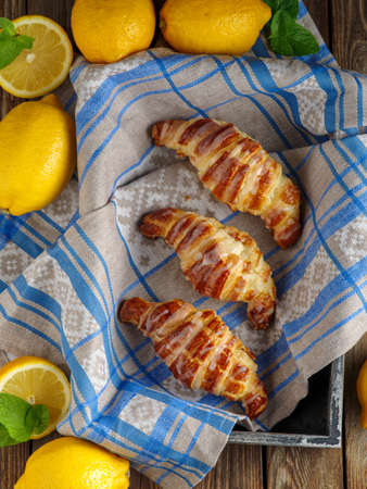 Homemade fresh croissants with lemon icing, top view.の写真素材