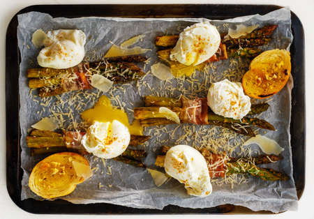 Asparagus in bacon with egg poached, croutons and Parmesan cheese. Top view.の写真素材