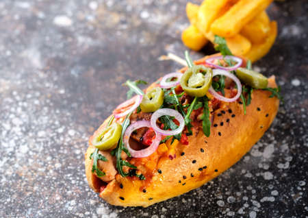 Big hot dog with greens, onion and jalapeno pepperの写真素材