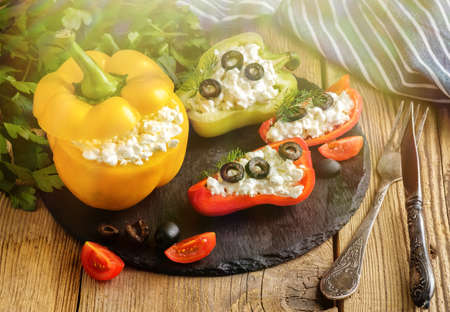 Bulgarian pepper stuffed with cheese with greens and olivesの写真素材