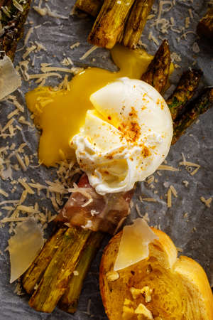 Asparagus in bacon with egg poached, croutons and Parmesan cheese. Top view. Close Up.の写真素材