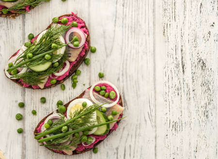 Sandwich with herring, horseradish and fresh herbs. Top view.の写真素材