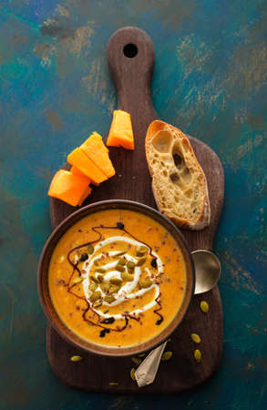 Delicious homemade pumpkin soup with basil leaves. Top viewの写真素材