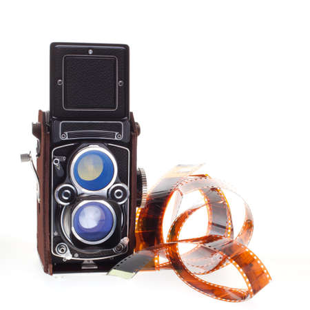 historic vintage camera with negatives in color on white backgroundの写真素材