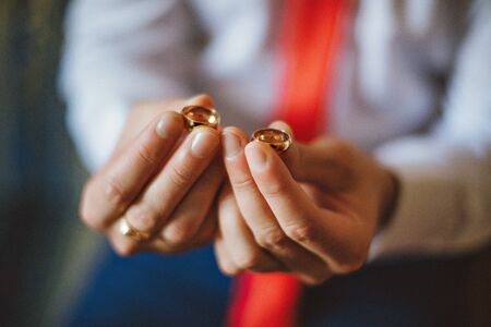 gold wedding rings at the wedding in man's handsの写真素材