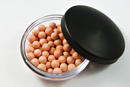 ball powder for face in the round package on white background