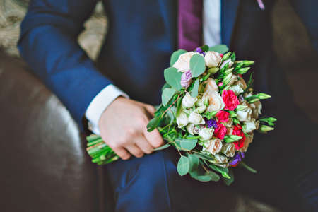 The groom holding a wedding bouquetの写真素材