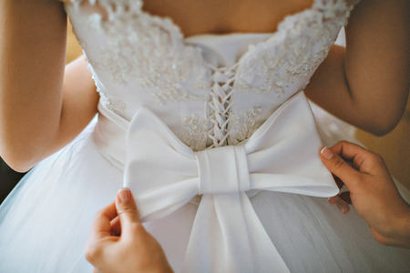 wedding gown being tied up at back great detail closeupの写真素材