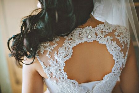 wedding gown being tied up at back great detail closeupの写真素材