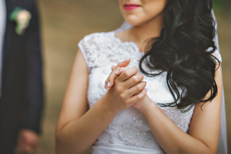 Hands of the bride and white bride dress.の写真素材