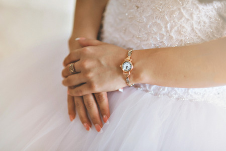 Hands of the bride and white bride dress.の写真素材