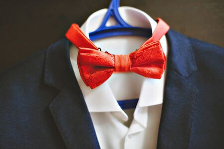 Photo of a blue suit with white shirt and red tie.の写真素材