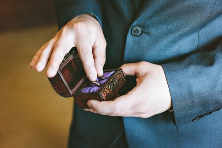 Wedding rings in the hands of men.の写真素材