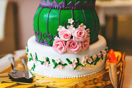 Green purple wedding cake with pink flowers, in an Oriental styleの写真素材