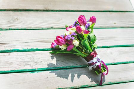 Wedding bouquet on a wooden pier. Purple white flowersの写真素材