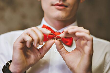 Wedding rings in the hands of men.の写真素材