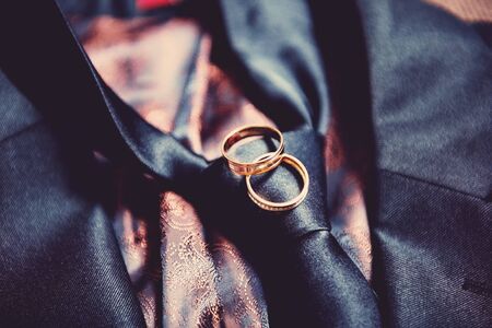 Two wedding rings on mens tieの写真素材