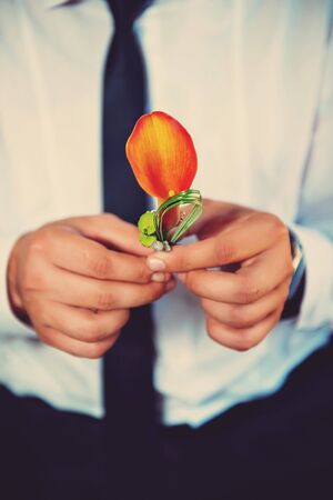 man holding a boutonniere orange Calla liliesの写真素材