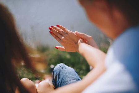 Newly wed couple's hands with wedding ringsの写真素材