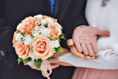 Newly wed couple's hands with wedding rings.の写真素材