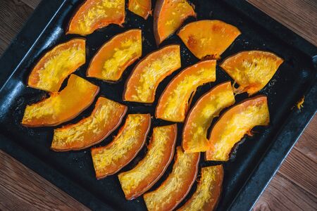 Baked pumpkin slices with honey,healthy dessert on wooden backgroundの写真素材