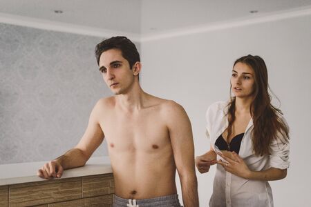 Loving couple in the kitchen. The problem between the young woman and manの写真素材