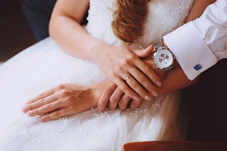 Groom and brides hands with rings, closeup viewの写真素材