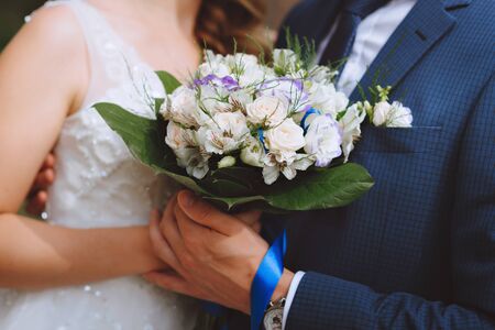 Groom and brides hands with rings, closeup view.の写真素材