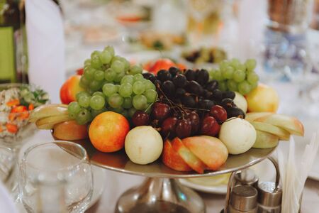 A fruit plate. Tangerines, grapes kiwi Partial focusの写真素材