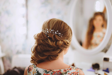 The decoration of the bride. Braided silver hair ornament in an elegant wedding the bride's hairstyleの写真素材
