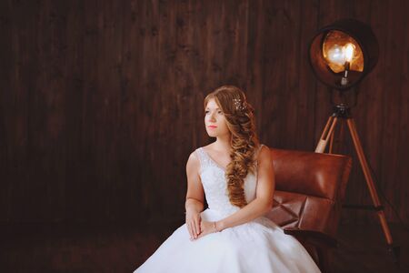 Portrait of the bride. In a white wedding dress. In the Studio loft styleの写真素材