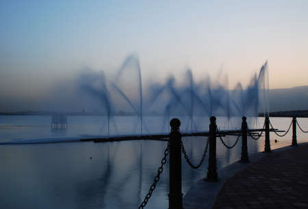 Fountain and poles in the evening at Tunis lake, Tunisia の写真素材