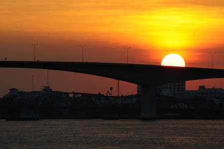 Sunset at riverside and bridges across Chaopraya river in Bangkok, Thailandの写真素材