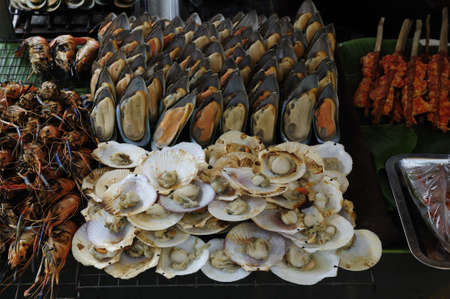 Fresh shrimps, mussels, scallops on grillの写真素材