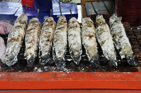 Fresh salted fishes on grill