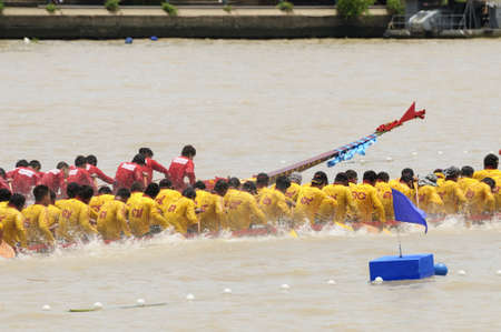 Bangkok, Thailand - August 25,2013 - Two rowing teams in full speed during Thai Long-tailed Boat...