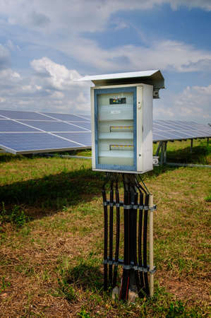 Electricity box and solar panels at solar power plant 