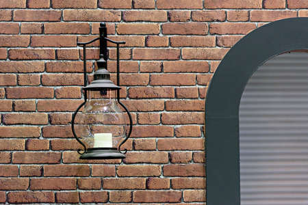 Antique Lantern on a red Brick Wallの写真素材