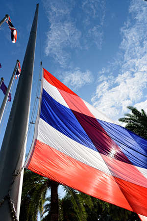 Thai flag backlit by the sun on blue skyの写真素材