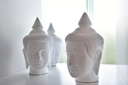 Buddha heads on backlit backgroundの写真素材