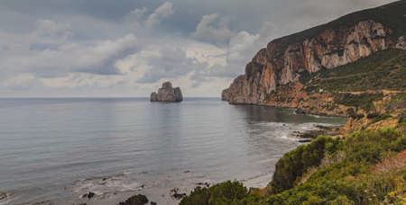 pan di sugar rock, limestone formation in front of masua beach, south sardiniaの写真素材