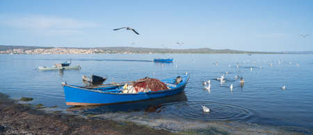 Boat in the water. Fishing boat in the calm waters of the pond of santa caterina in southern sardiniaの写真素材