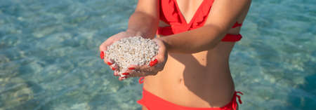 sand made up of small colored stones on the beach of Is Arutas in Sardinia, Italy. Is Arutas is...