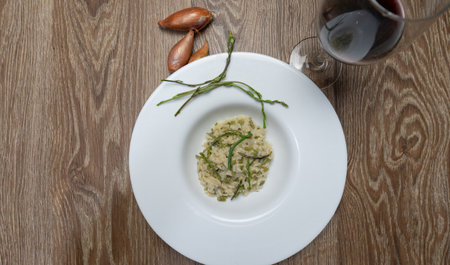 risotto with wild asparagus ,asparagus acutifolius, on white plateの写真素材