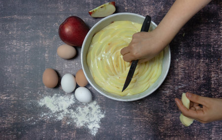 apple pie being prepared with ingredients and ladles, italian foodの写真素材