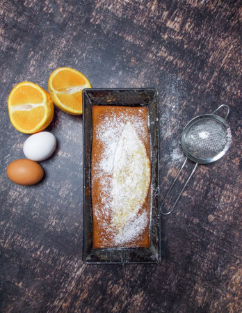 plum cake flavored with oranges and cinnamon and icing sugarの写真素材